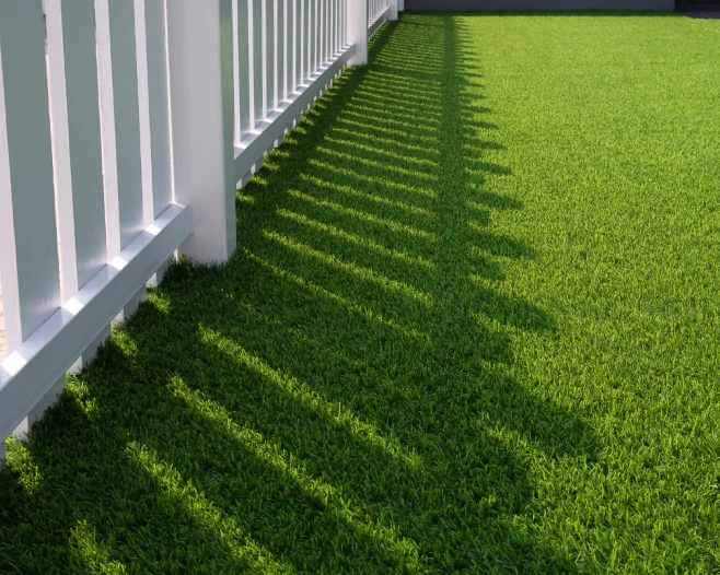 white wooden fence on green artificial turf